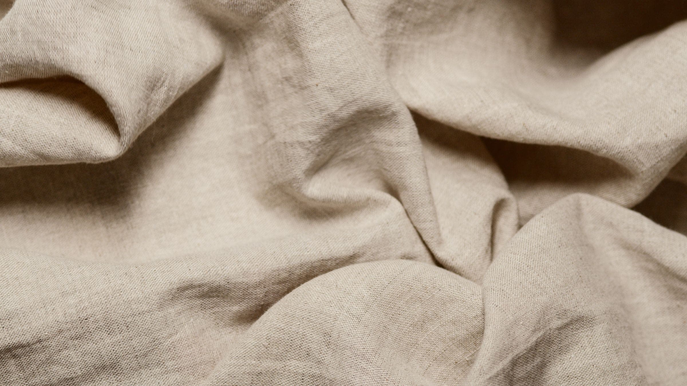 Crumpled warm ivory linen-cotton with soft folds