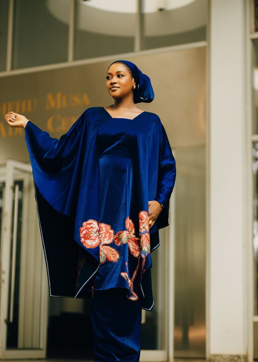 Inspiration photo, not our product: A royal blue kaftan with wide sleeves and large embroidered flowers near the hem