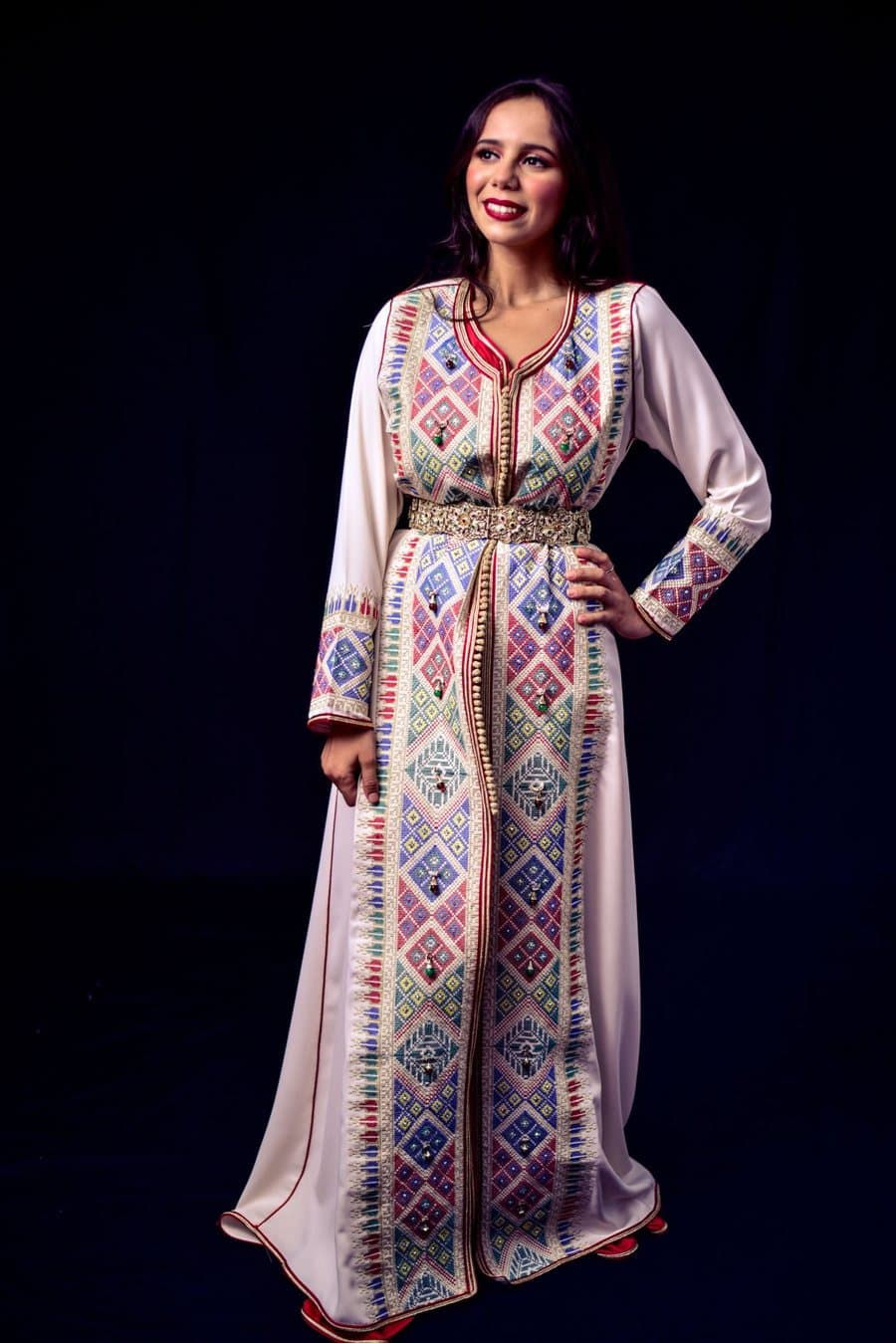 Inspiration photo, not our product: An ivory Moroccan style kaftan with colourful geometric embroidery and a belt