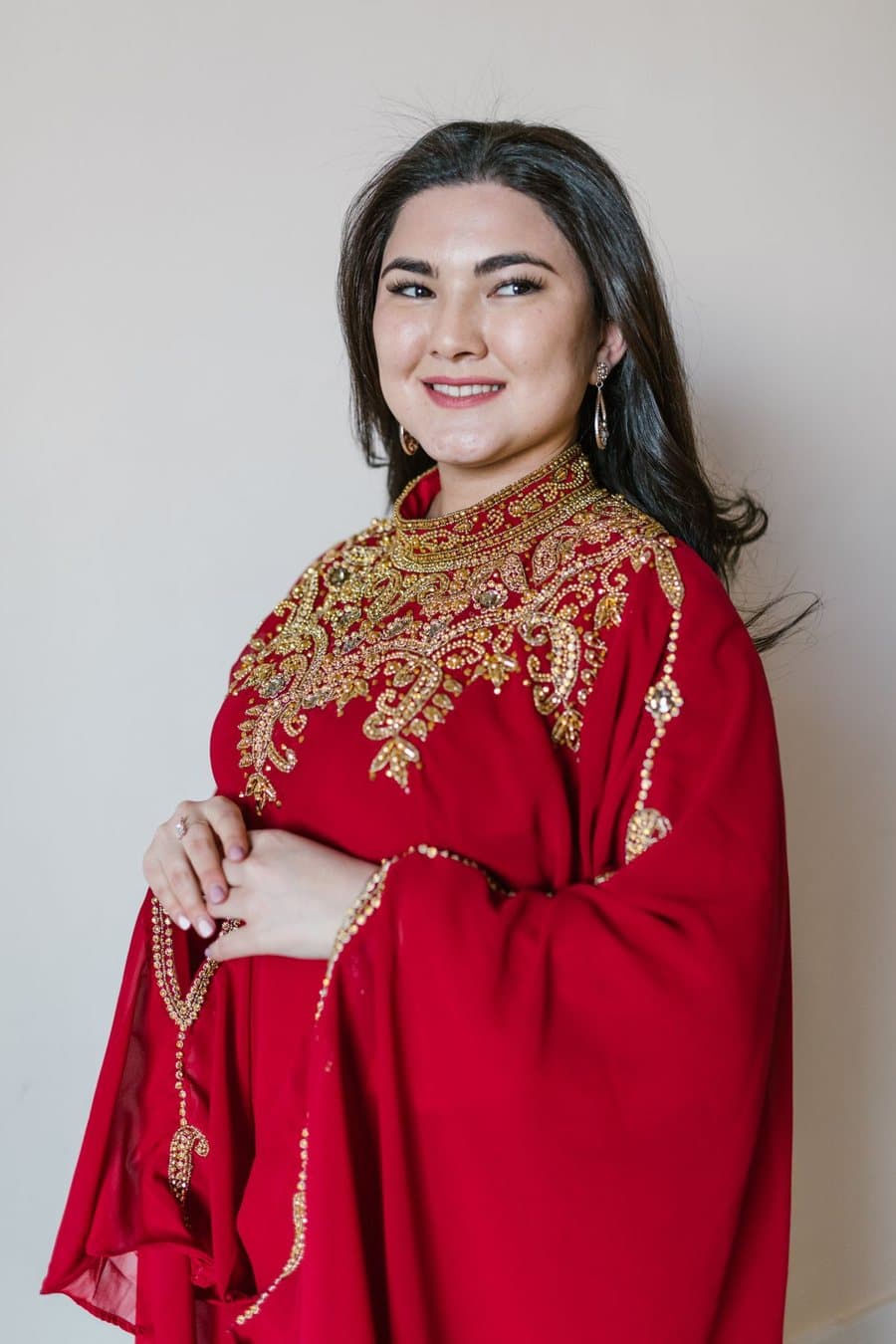 Inspiration photo, not our product: A red kaftan with gold embroidery around a high neckline